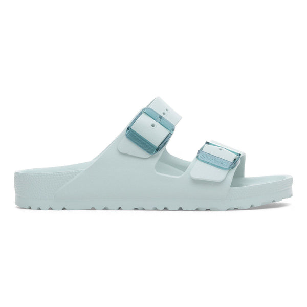 Light green sandals with white straps on a white background