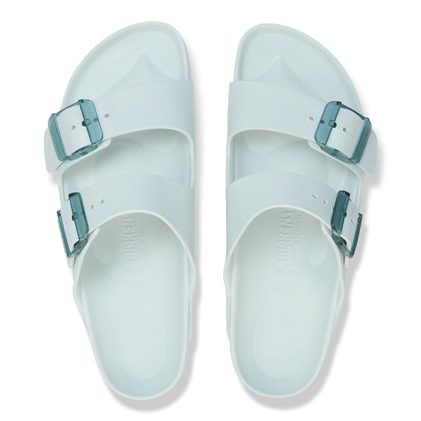 Pair of light blue sandals with buckles on a white background