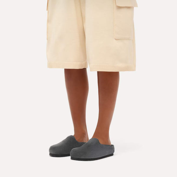 Charcoal grey suede clog on a white background