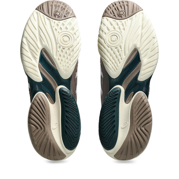 Close-up of a pair of ASICS tennis shoes with detailed sole pattern on a white background.