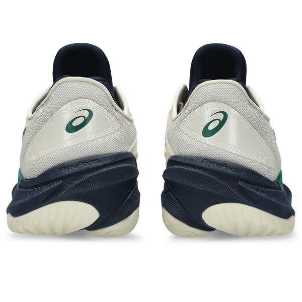 White running shoes with green logo and black soles on a white background
