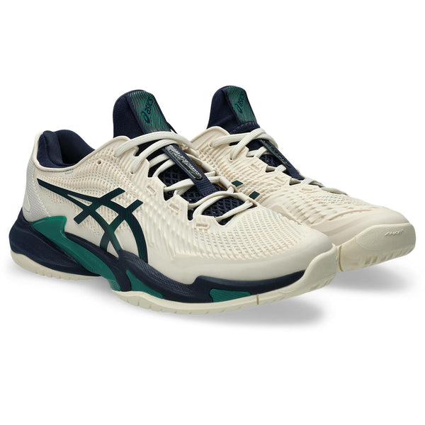 A pair of white and navy running shoes with green accents on a white background