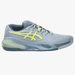 Gray athletic shoe with yellow accents on a white background