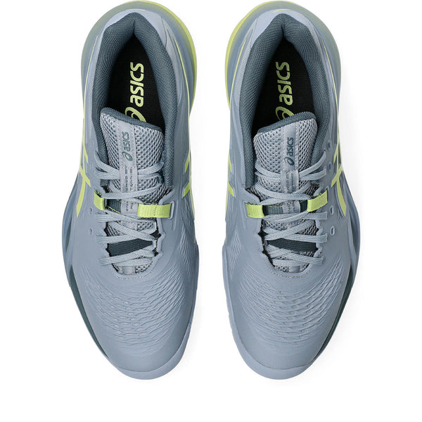 Gray running shoes with yellow accents and Asics logo on a white background