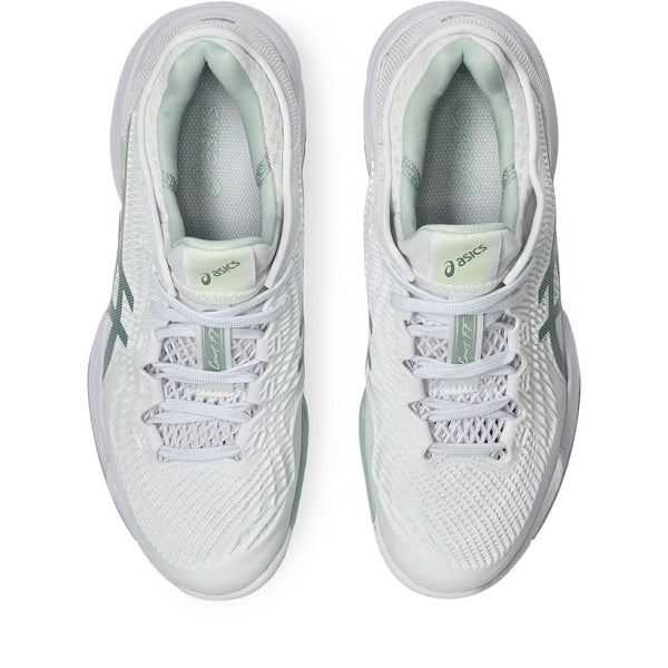White running shoes with green accents on a white background