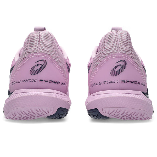 Purple running shoes with 'Solution Speed' text on a white background