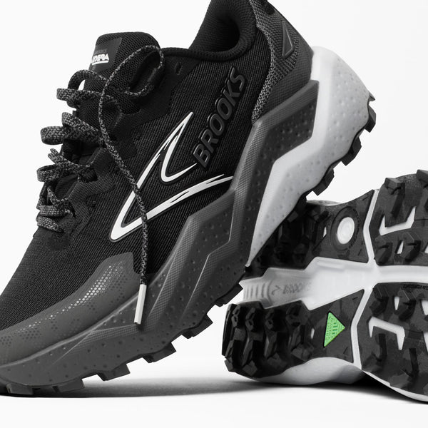 Black and gray running shoe with visible 'Brooks' branding on a white background
