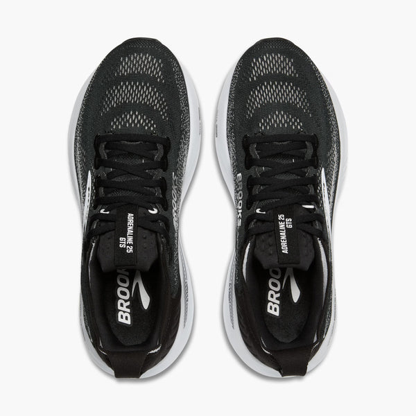 Black running shoes with white soles on a white background