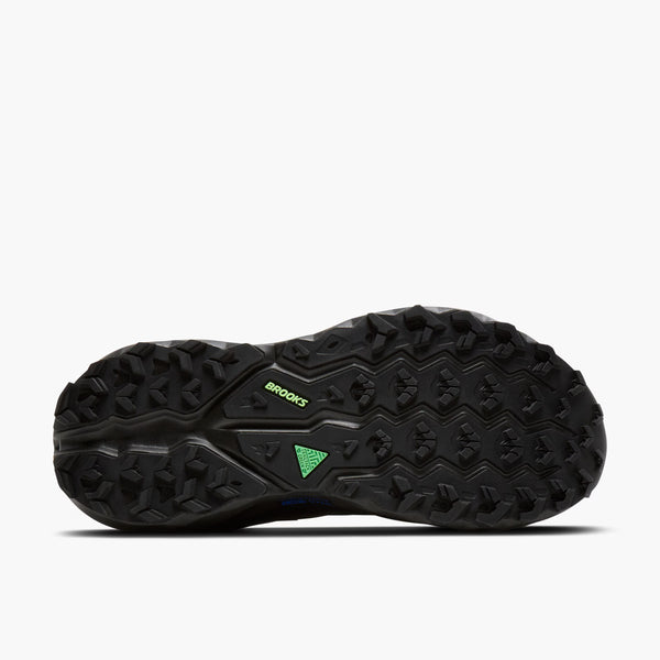 Black athletic shoe with green accents on a white background