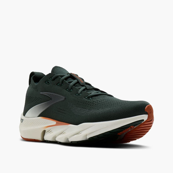 A dark green running shoe with a white midsole and orange outsole accents, shown from a side profile on a light gray background.