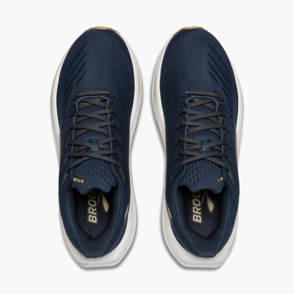 Pair of navy blue running shoes with white soles on a white background