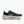 Navy running shoe with white sole on a white background