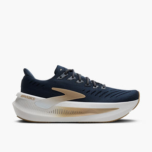 Navy running shoe with white sole on a white background