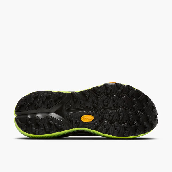 Black and green sole of a shoe on a white background