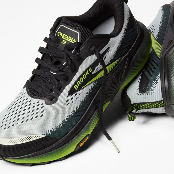Brooks running shoe with black, gray, and green design on a white background