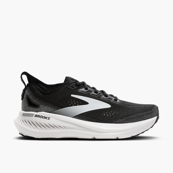 Black running shoe with white sole on a light gray background
