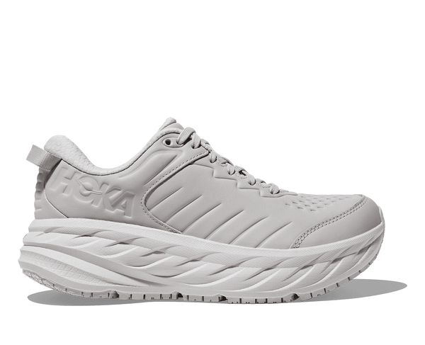 A pair of white Hoka women's sneakers with a mesh upper and a rubber outsole.
