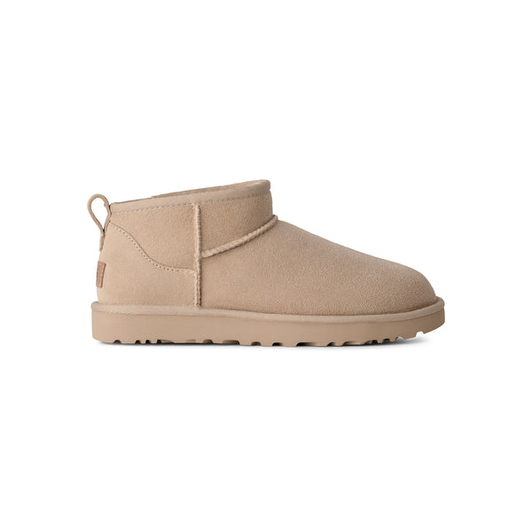 Ankle length beige slipper boot on a white background
