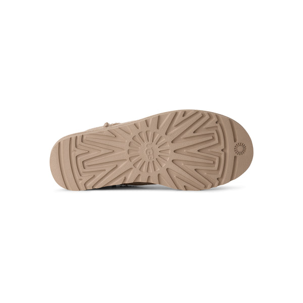 Ankle length beige slipper boot on a white background