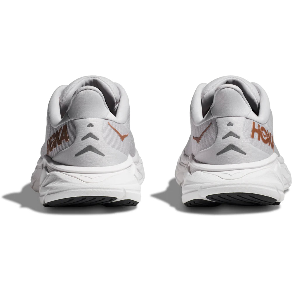 Back view of the Women's Arahi 6 by HOKA in the color Nimbus Cloud/Rose Gold