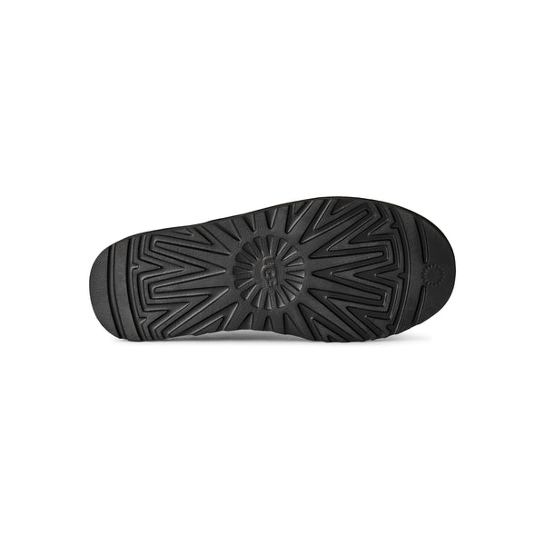 Black slip on slipper on a white background
