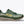 Green trail running shoe with 'Hoka' branding on a white background