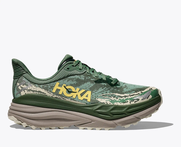 Green trail running shoe with 'Hoka' branding on a white background
