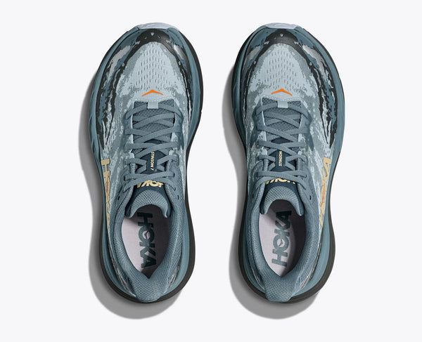 Pair of gray running shoes with visible brand logo on a white background