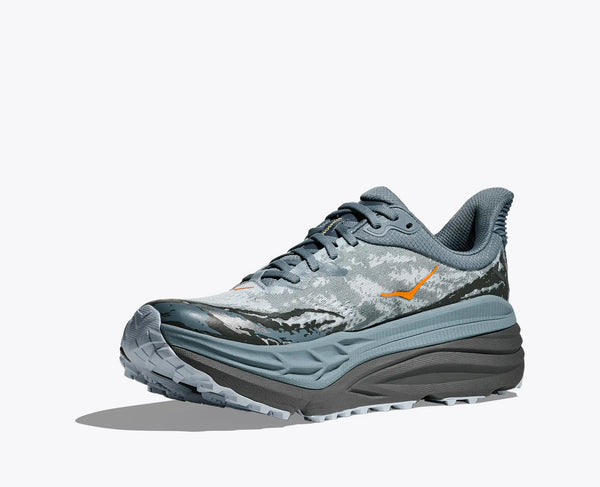 Gray and black sneaker with mountain design on a white background