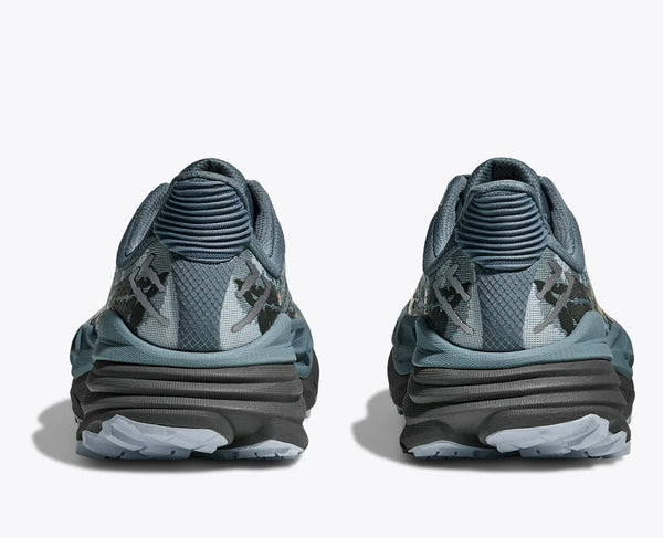 Pair of blue athletic shoes with textured design on a white background