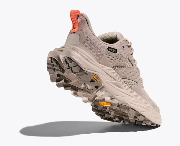 Gray hiking shoe with orange accents on a white background