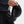 Person holding a black hat with a unique design on a light gray background