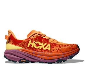 A pair of men's running shoes with a prominent orange and pink upper design, featuring the brand name 'hoka' and the model name 'Speedgoat 6'.
