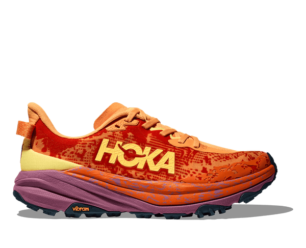 A pair of men's running shoes with a prominent orange and pink upper design, featuring the brand name 'hoka' and the model name 'Speedgoat 6'.