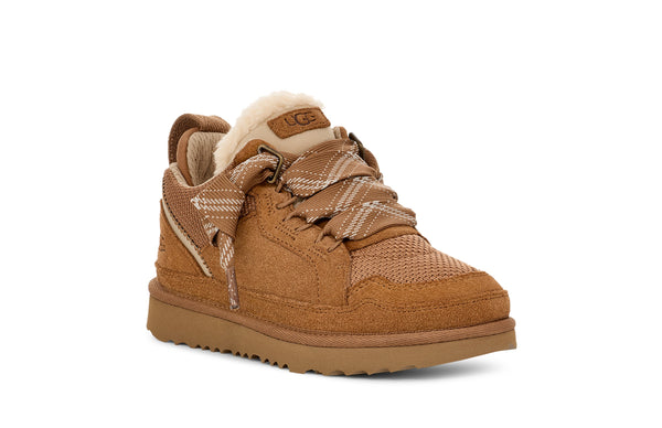 Kids tan sneaker on a white background