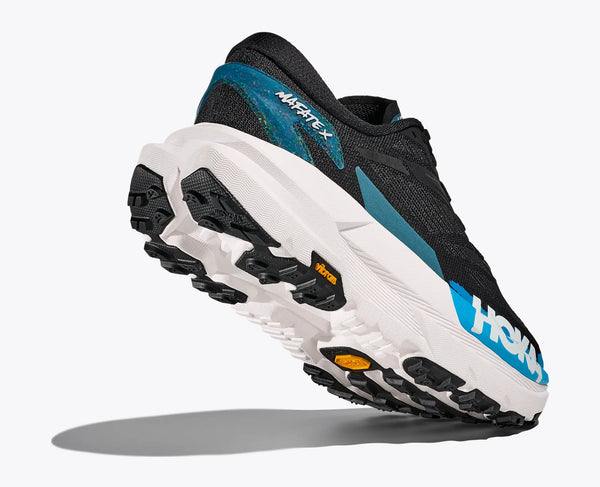 Black and blue running shoe with white sole on a light gray background