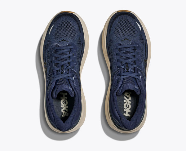 Pair of blue running shoes with beige soles on a white background