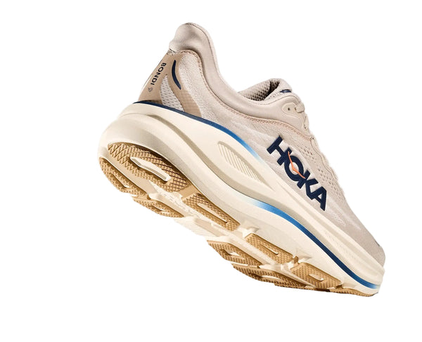 Beige running shoe with blue accents on a white background