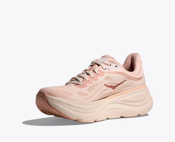 The medial side of a light pink running shoe on a white background