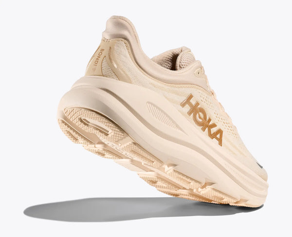 Beige running shoe with 'Hoka' branding on a white background