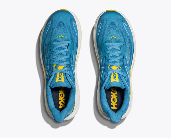 Blue running shoes with yellow accents on a white background