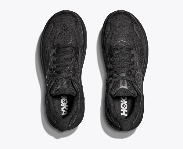 An all black Hoka shoe from the top down look that focuses on the great knit material