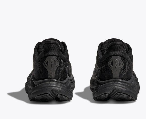 Black athletic shoes shown from the back on a white background