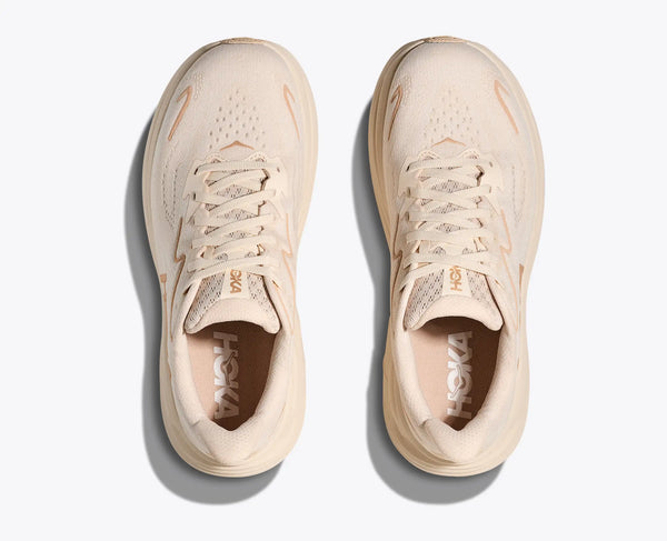 Pair of beige sneakers with 'Hoka' branding on a white background