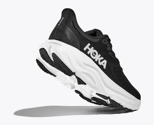 Clouse up view of the heel and outsole of a black running shoe with white sole on a white background