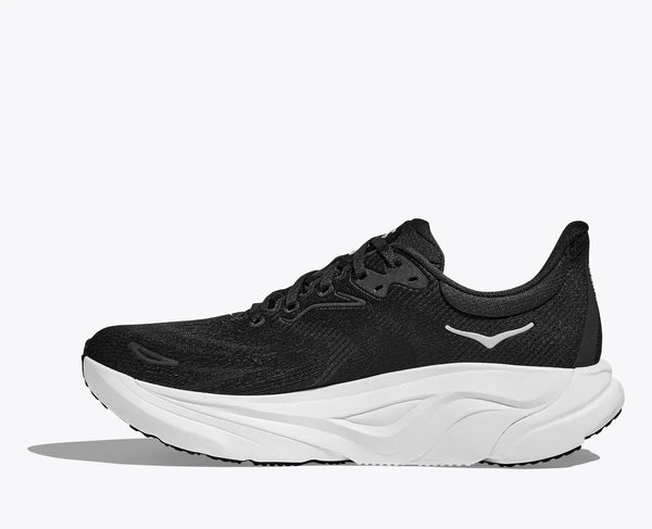 Black running shoe with white sole on a white background