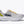 Gray Arahi 8 running shoe with yellow accents and 'Hoka' branding on a white background.