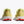 The heel area of these yellow running shoes with red accents on a white background
