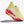 Yellow running shoe with red sole on a white background