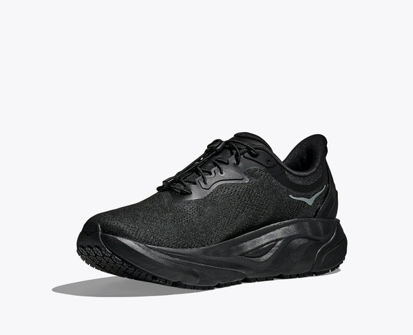 The medial side of a black athletic shoe on a white background